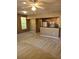 Open living room with neutral carpet, view to kitchen, and plenty of natural light at 5125 Palm Springs Blvd # 1101, Tampa, FL 33647