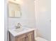 Bathroom features a modern vanity with sink, mirror, and a toilet at 5600 Bay Ne St, St Petersburg, FL 33703