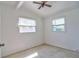 A bright bedroom with two windows and a ceiling fan for added comfort and natural light at 5600 Bay Ne St, St Petersburg, FL 33703