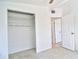 Bedroom features a closet with shelving, and an attached bathroom at 5600 Bay Ne St, St Petersburg, FL 33703