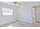 Bright bedroom with ceiling fan, window, and neutral walls at 5600 Bay Ne St, St Petersburg, FL 33703