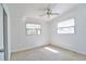 Bedroom with ceiling fan and a sun-filled window with a view to the outside at 5600 Bay Ne St, St Petersburg, FL 33703