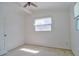 Sunlit bedroom with a ceiling fan, white walls, and a window that enhances the room's brightness at 5600 Bay Ne St, St Petersburg, FL 33703