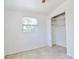 Bright bedroom featuring a ceiling fan, closet with shelves, and window providing natural light at 5600 Bay Ne St, St Petersburg, FL 33703