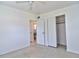 Bedroom with ceiling fan and closet adjacent to the bathroom at 5600 Bay Ne St, St Petersburg, FL 33703