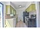The kitchen includes a stainless-steel sink, green cabinets, and appliances at 5600 Bay Ne St, St Petersburg, FL 33703