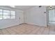 Bright living room with tiled floor, window and a white door at 5600 Bay Ne St, St Petersburg, FL 33703