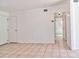 A living room with neutral-colored flooring, white walls, and doorways at 5600 Bay Ne St, St Petersburg, FL 33703