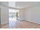 Spacious living room featuring neutral tile flooring and a bright, open layout to kitchen at 5600 Bay Ne St, St Petersburg, FL 33703