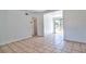 Open living room with neutral flooring, white walls, and entryways at 5600 Bay Ne St, St Petersburg, FL 33703