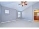 Large bedroom offering neutral carpet, ceiling fan, and large windows for ample natural light at 5704 Kingletsound Pl, Lithia, FL 33547