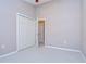Neutral bedroom with white trim, plush carpeting, and a spacious closet with folding doors at 5704 Kingletsound Pl, Lithia, FL 33547