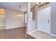 Inviting entryway with hardwood floors, stylish lighting, and a view into the dining area at 5704 Kingletsound Pl, Lithia, FL 33547