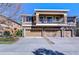 Exterior elevation of a townhome featuring a balcony, stone accents, and a three-car garage at 5704 Kingletsound Pl, Lithia, FL 33547
