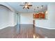 Spacious living room with hardwood floors, slider door, and an open view of the kitchen area at 5704 Kingletsound Pl, Lithia, FL 33547