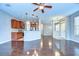 Open-concept living space featuring hardwood floors and a modern kitchen with stainless steel appliances at 5704 Kingletsound Pl, Lithia, FL 33547