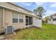 Exterior view of backyard with lush lawn and an inviting screened-in patio area at 585 Black Lion Ne Dr, St Petersburg, FL 33716