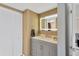 Beautiful bathroom with illuminated mirror, neutral decor, and modern gray vanity at 6009 Sea Ranch Dr # 307, Hudson, FL 34667
