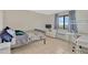 Bright bedroom with tile flooring and a window with light blue curtains at 6009 Sea Ranch Dr # 307, Hudson, FL 34667