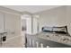 Comfortable bedroom features neutral walls, tile flooring, and open doorway to living area at 6009 Sea Ranch Dr # 307, Hudson, FL 34667