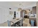 Open floor plan dining and kitchen area with modern lighting and tiled floors at 6009 Sea Ranch Dr # 307, Hudson, FL 34667
