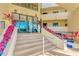 Welcoming building entrance featuring stairs, plants, and glass doors at 6009 Sea Ranch Dr # 307, Hudson, FL 34667