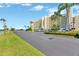 Exterior view of the building with palm trees and lush landscaping at 6009 Sea Ranch Dr # 307, Hudson, FL 34667