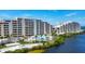 Beautiful beachfront condo complex with a sparkling blue pool and lush landscaping at 6009 Sea Ranch Dr # 307, Hudson, FL 34667