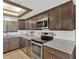 Stainless steel appliances in a beautifully updated kitchen with tiled floors at 6009 Sea Ranch Dr # 307, Hudson, FL 34667