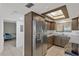 Modern kitchen with stainless steel refrigerator and a view to the bedroom at 6009 Sea Ranch Dr # 307, Hudson, FL 34667