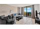 Living room with a sofa, armchair, and a large balcony providing ocean views at 6009 Sea Ranch Dr # 307, Hudson, FL 34667