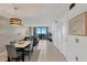 Bright condo interior with dining area, living space, and balcony overlooking the ocean at 6009 Sea Ranch Dr # 307, Hudson, FL 34667
