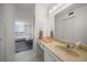 A bathroom features tile flooring, a vanity and mirror, and an open view into the bedroom at 6279 Sun Blvd # 605, St Petersburg, FL 33715