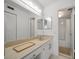 A bathroom features a mirror, vanity, and a view into the shower and linen closet at 6279 Sun Blvd # 605, St Petersburg, FL 33715