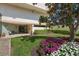 Exterior entrance to the building, featuring a lush garden and a cozy bench at 6279 Sun Blvd # 605, St Petersburg, FL 33715