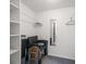 A closet with a mirror, seating, carpeting, and built in shelving at 6279 Sun Blvd # 605, St Petersburg, FL 33715