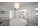 Dining area featuring stylish lighting and mirrored wall with access to the kitchen at 6279 Sun Blvd # 605, St Petersburg, FL 33715