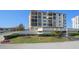 Low exterior shot of a multi-story condo building, showcasing balconies and well-maintained landscaping at 6279 Sun Blvd # 605, St Petersburg, FL 33715