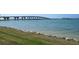 Scenic water view featuring lush grassy shoreline and a large bridge under a clear blue sky at 6279 Sun Blvd # 605, St Petersburg, FL 33715