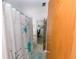 Bathroom featuring a shower with retro-design curtain, light walls, and modern fixtures at 6315 25Th N Ave, St Petersburg, FL 33710