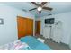 Bright bedroom with closet, ceiling fan, plush bedding, and white wicker furniture at 6315 25Th N Ave, St Petersburg, FL 33710