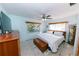 Cozy bedroom with light blue walls, natural light, and wooden accents at 6315 25Th N Ave, St Petersburg, FL 33710