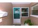 Close-up of the front door with a screen, sidelight window, and decorative brick accents at 6315 25Th N Ave, St Petersburg, FL 33710