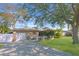 Lovely single-story home with brick accents, a well-kept lawn, and mature trees providing shade at 6315 25Th N Ave, St Petersburg, FL 33710