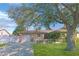 Inviting one-story residence featuring a brick facade, a garage, and a lush green lawn at 6315 25Th N Ave, St Petersburg, FL 33710