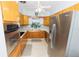 Charming kitchen featuring wood cabinets, stainless steel appliances, and a cozy window over the sink at 6315 25Th N Ave, St Petersburg, FL 33710
