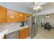 Open kitchen with wood cabinets and stainless steel appliances adjacent to the dining area at 6315 25Th N Ave, St Petersburg, FL 33710