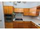 Cozy kitchen with wooden cabinetry, stainless steel oven, and electric cooktop, offering a functional cooking space at 6315 25Th N Ave, St Petersburg, FL 33710