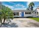 Charming single-story home with a well-manicured lawn and a bright blue front door at 735 Snell Isle Ne Blvd, St Petersburg, FL 33704