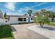 Inviting home with a well-manicured lawn, nice landscaping, and a vibrant blue front door at 735 Snell Isle Ne Blvd, St Petersburg, FL 33704